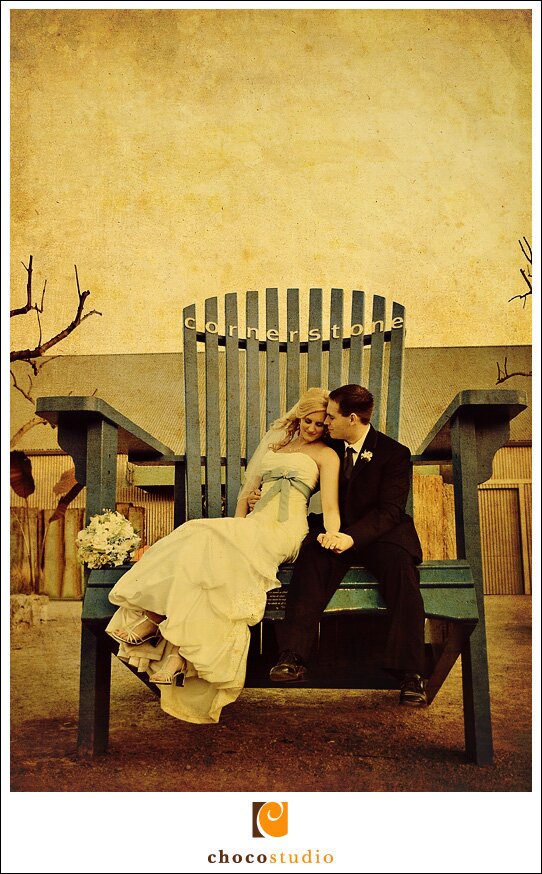 Bride and Groom on giant chair at Cornerstone Gardens Wedding