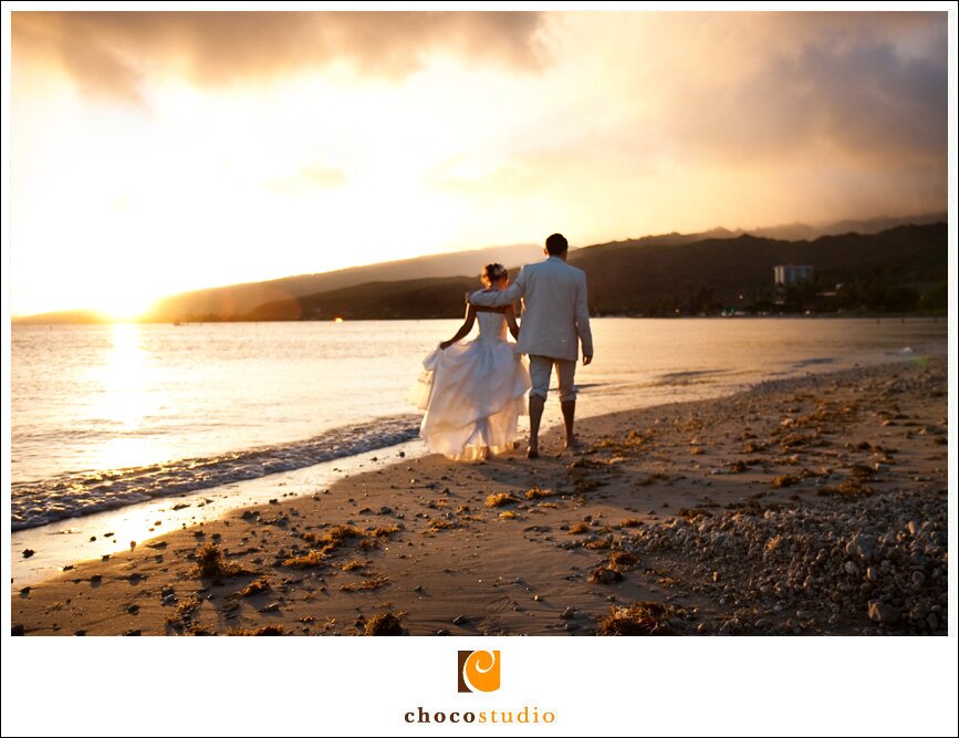 Bride and Groom walking at sunset on the beach