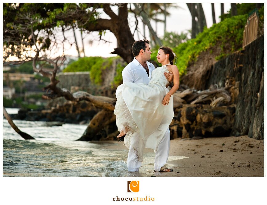 Groom carrying the bride on a beach